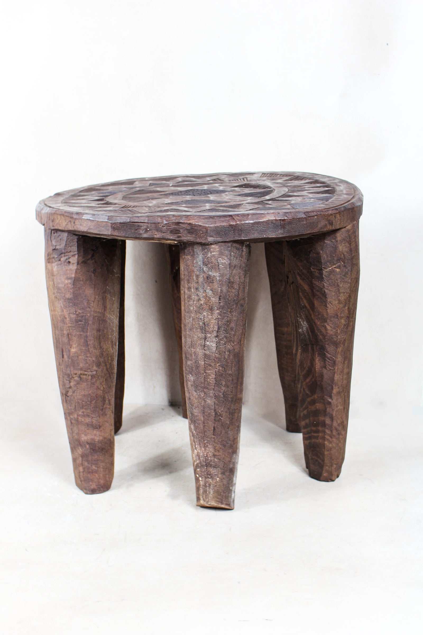 Hand-carved Nupe wood stool from Nigeria with incised geometric patterns