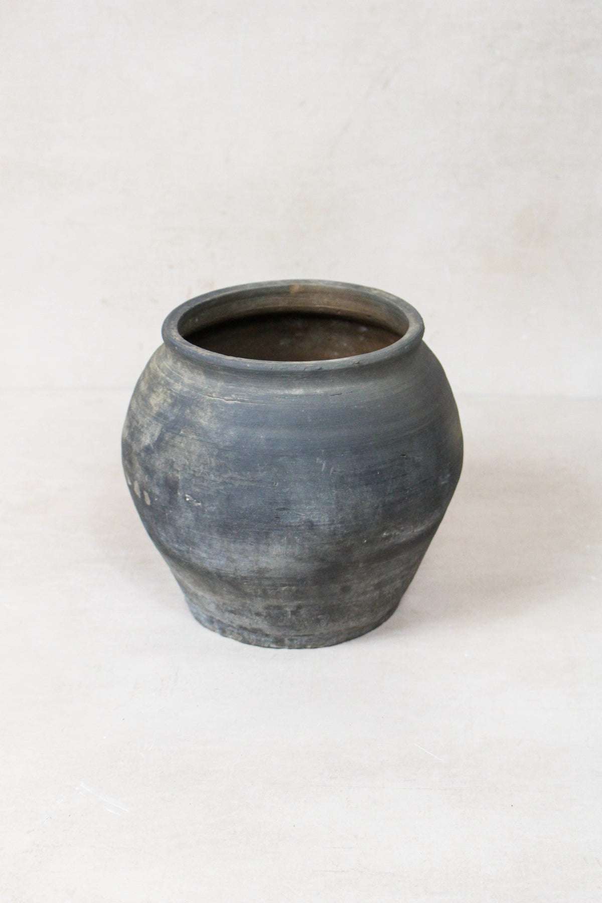 Vintage dark pot — side view showing the aged patina
