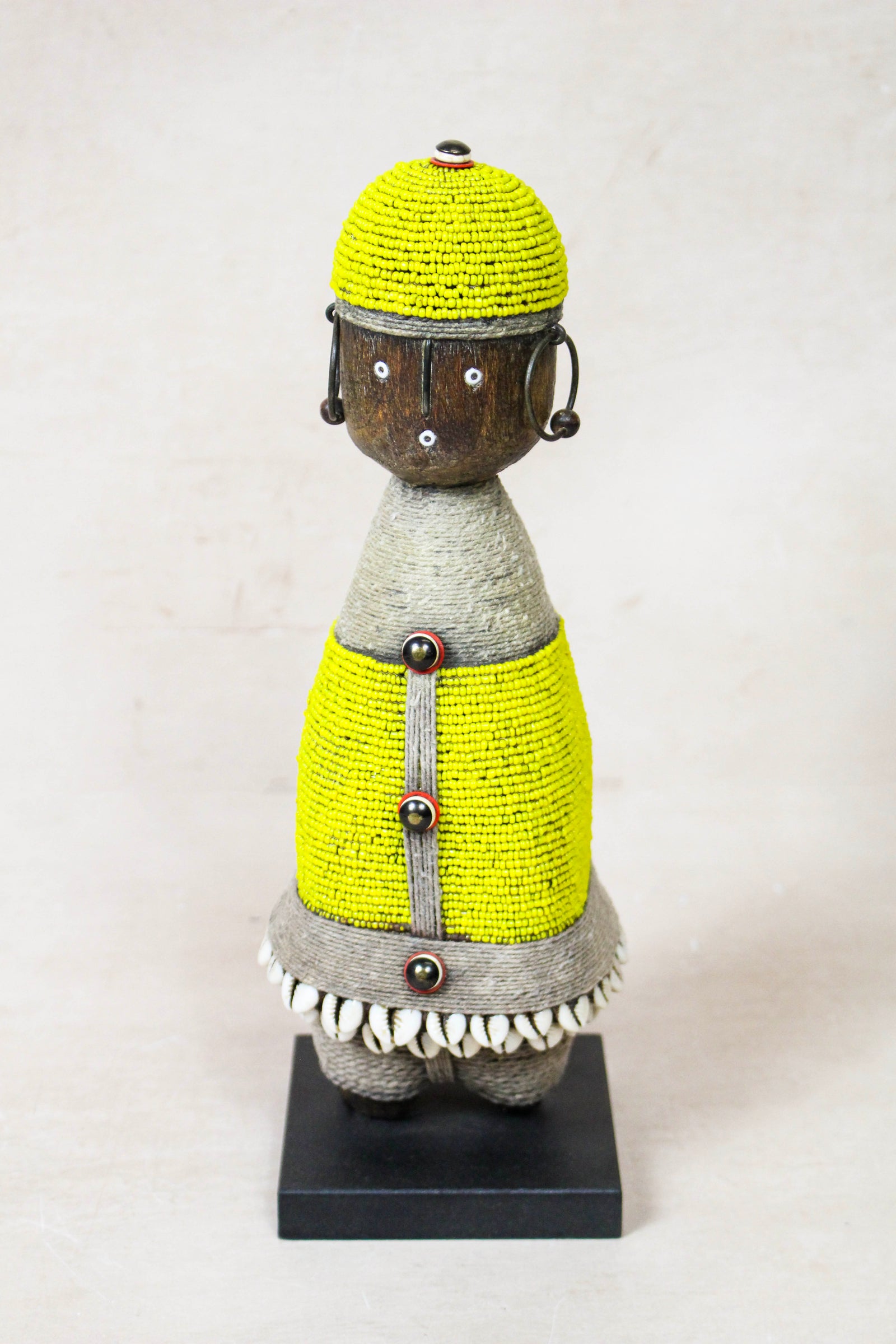 Hand-carved yellow beaded Namji doll from Cameroon