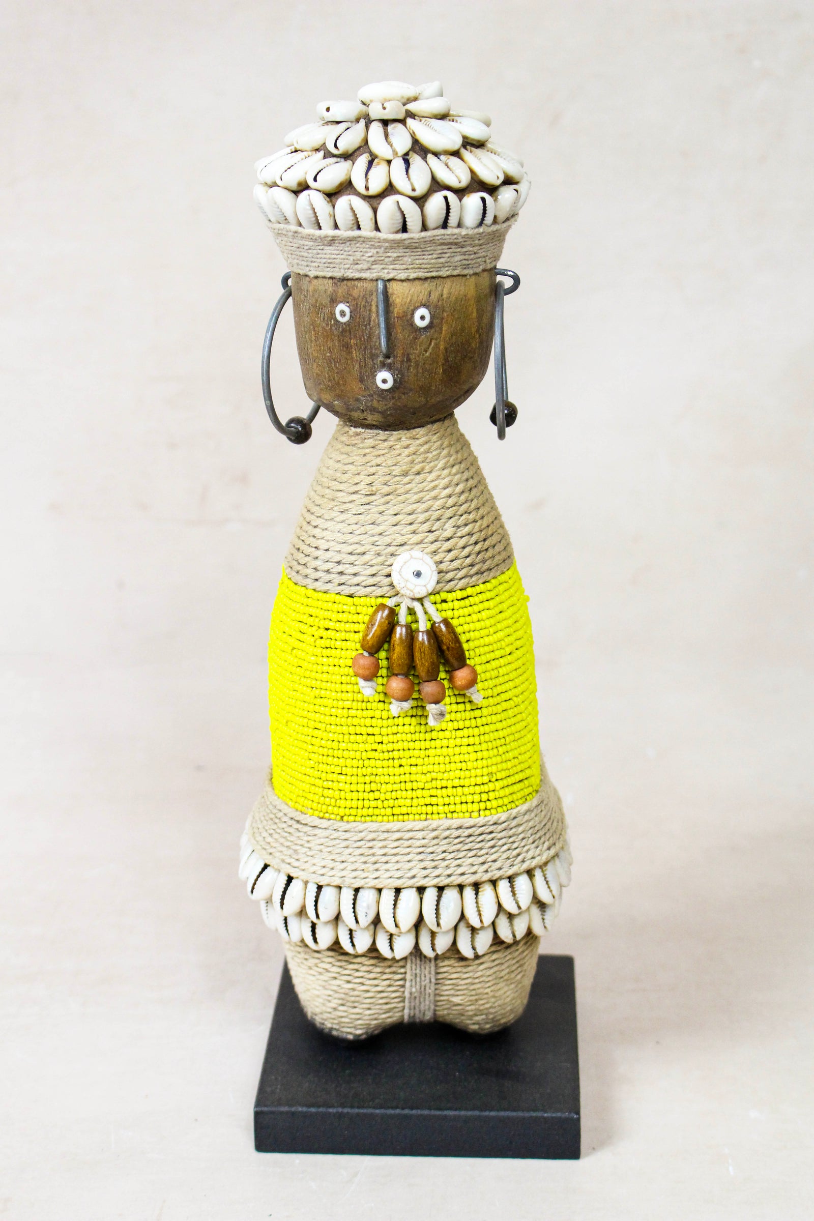 Hand-carved yellow beaded Namji doll from Cameroon