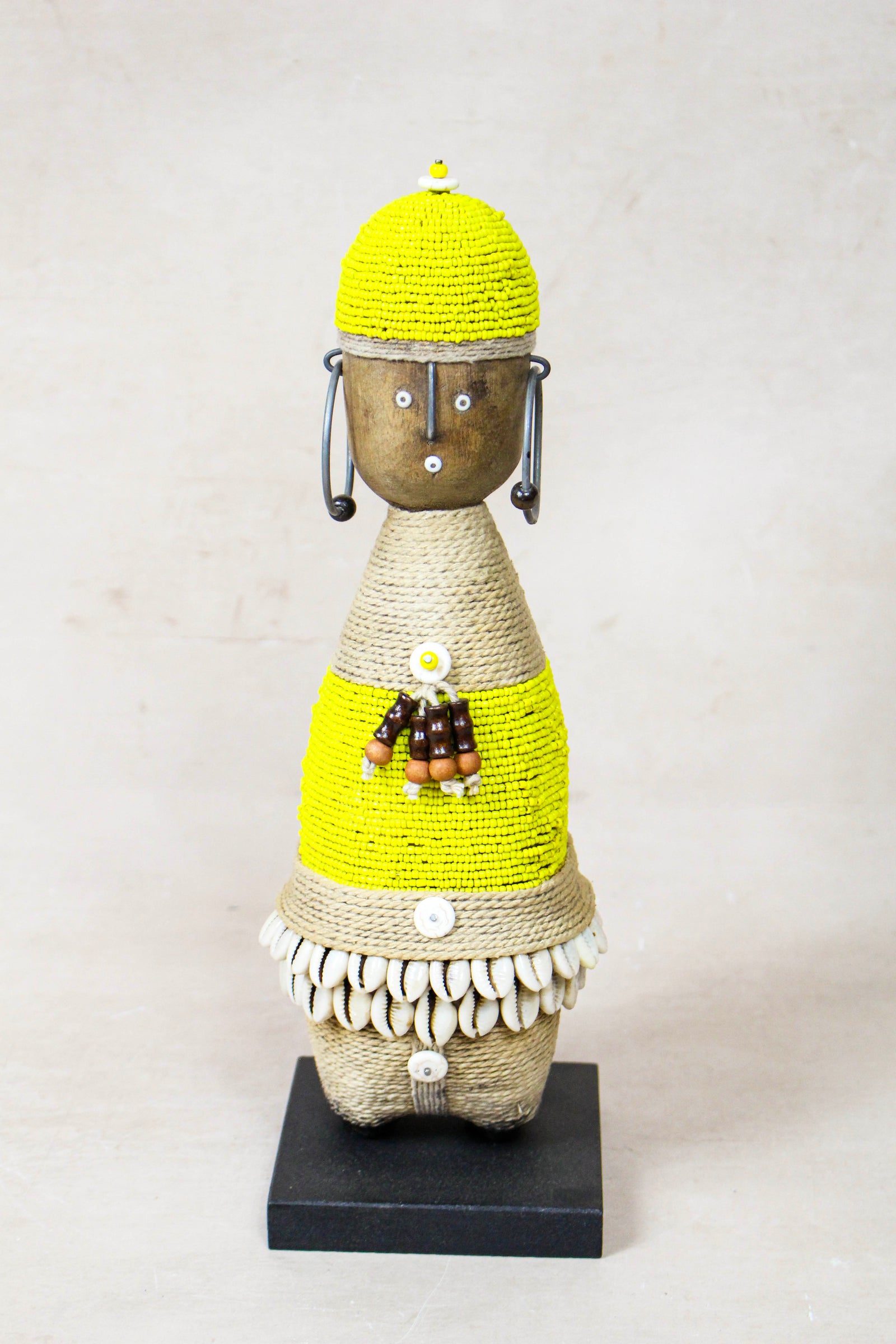Hand-carved yellow beaded Namji doll from Cameroon