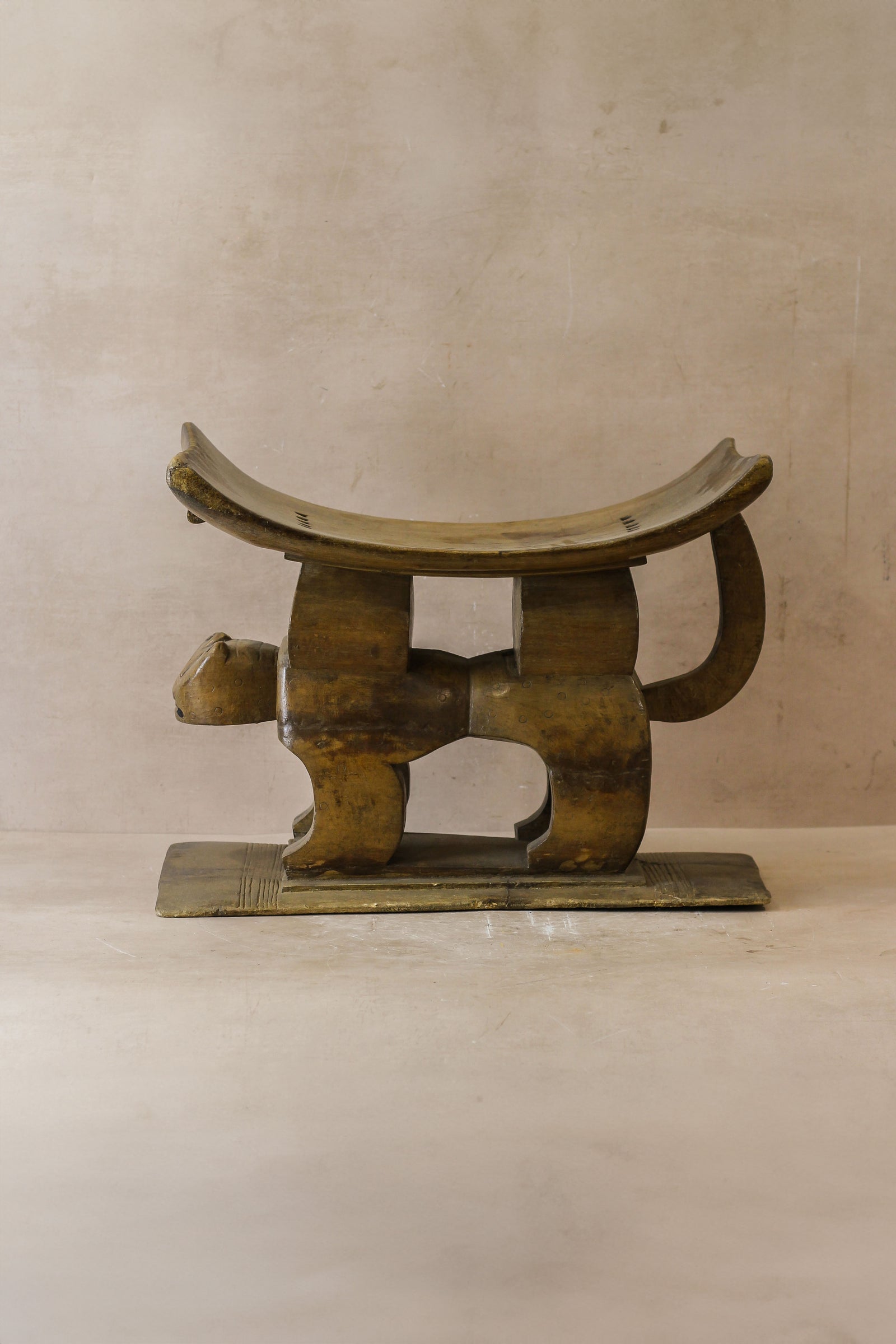 Hand-carved Ashanti stool from Ghana with crescent seat, carved from a single piece of wood