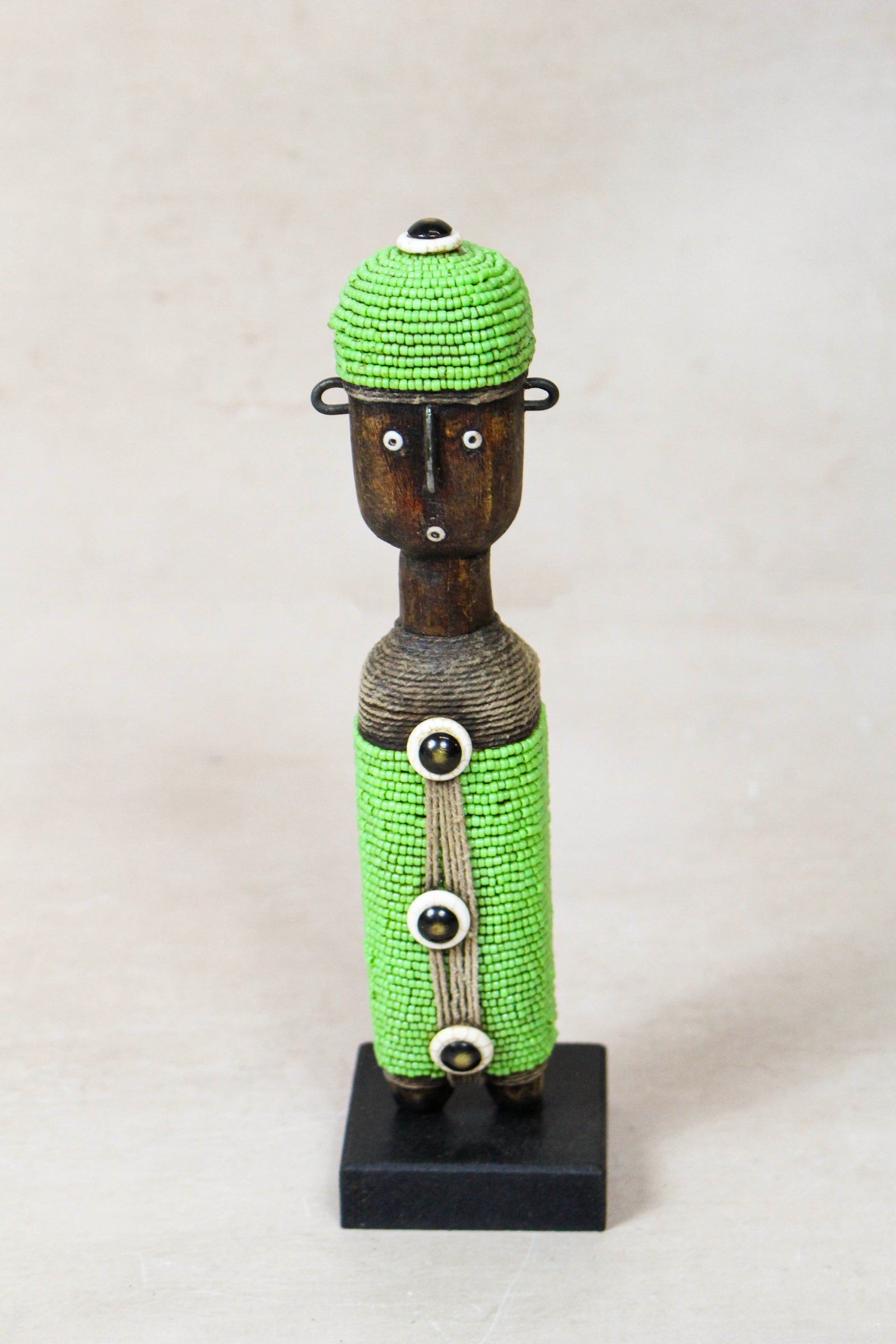 Hand-carved green beaded Namji doll from Cameroon