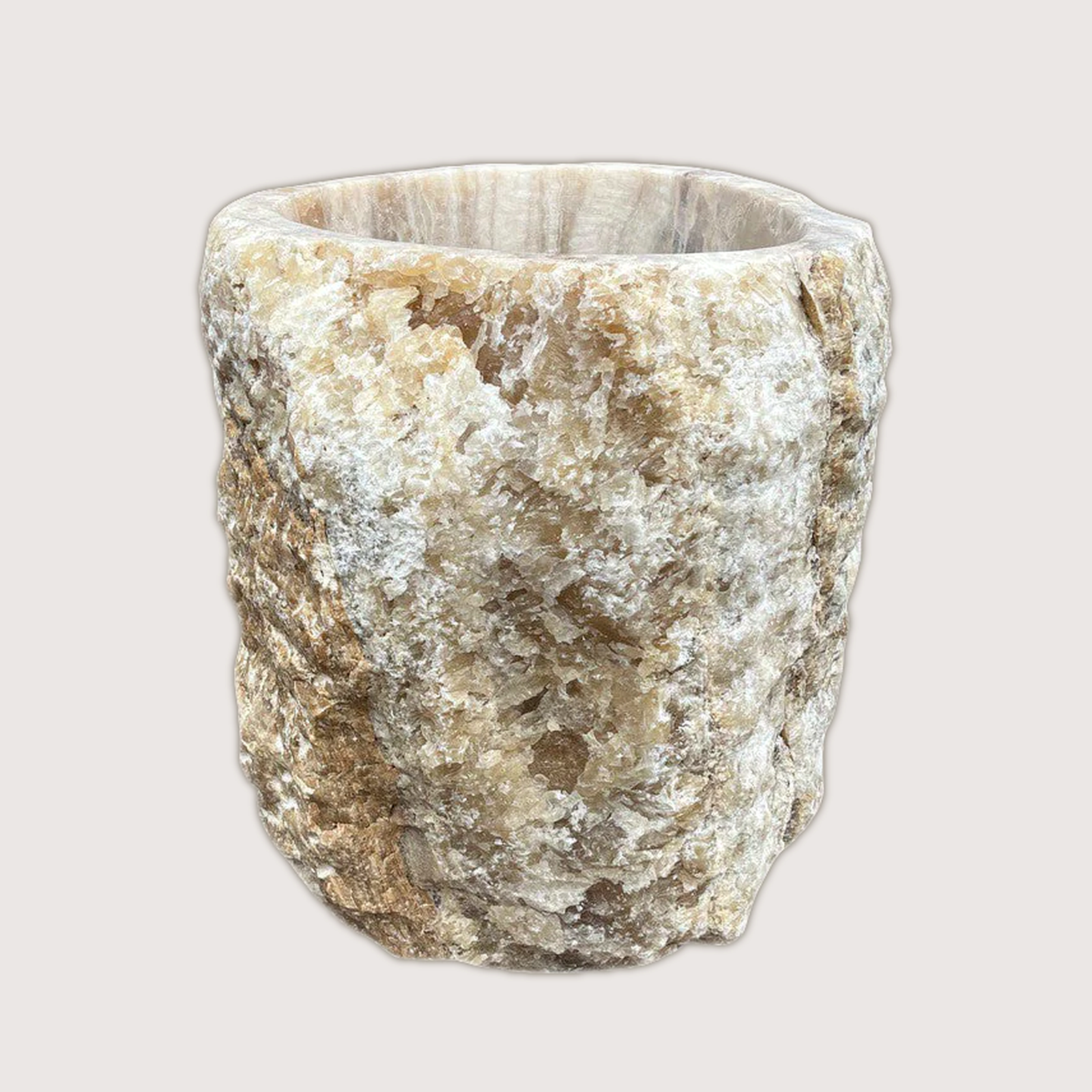 Large planter hand-carved from a single piece of raw onyx, the rugged natural outer edge left intact against a smoothly polished interior