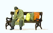 Hand-painted man resting on a bench, miniature terrarium figure, 1:87 scale