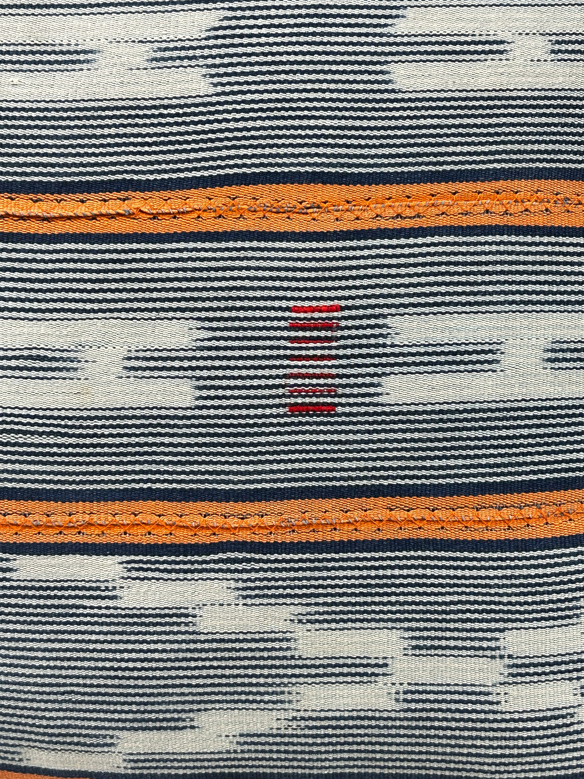 Baule cloth cushion — detail of the hand-stitched strip weave