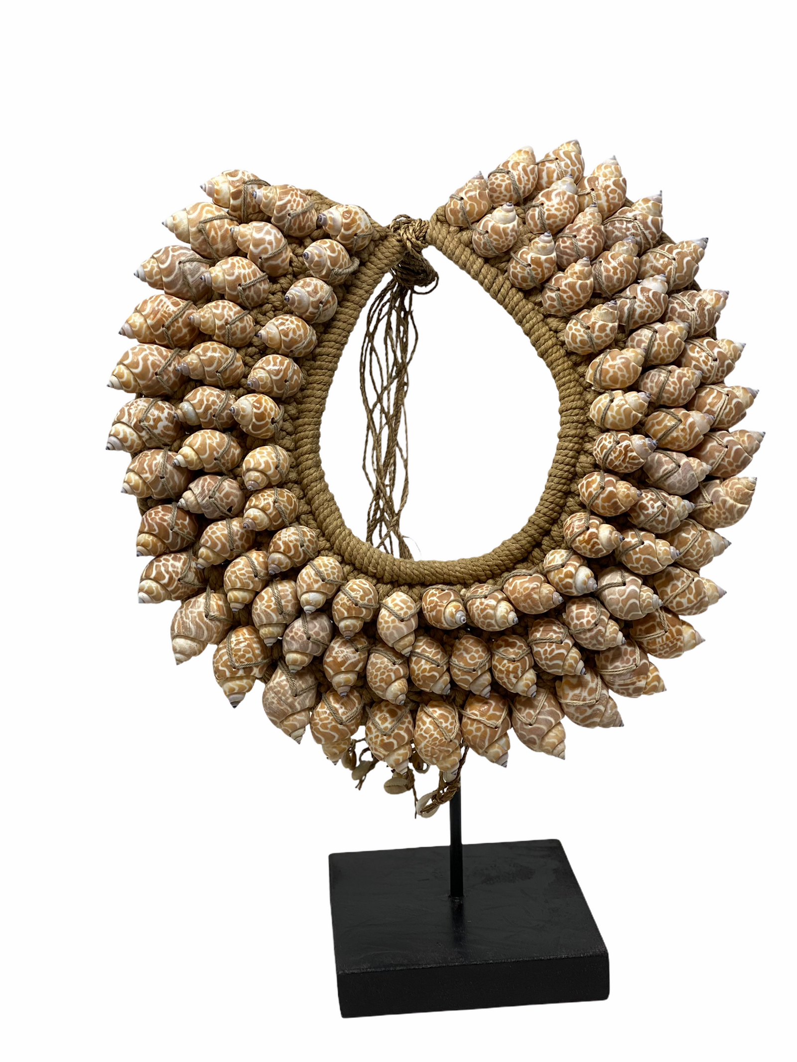 Handmade Indonesian shell necklace on a display stand