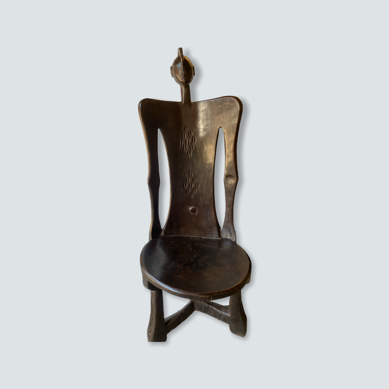 Hand-carved Makonde chair from Tanzania with a sculpted ancestor head on the backrest