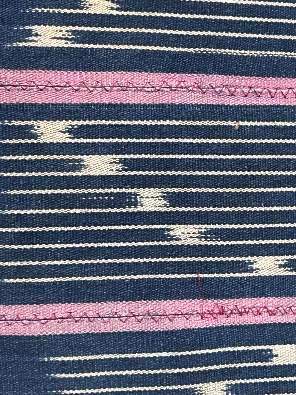 Baule cloth cushion — detail of the hand-stitched strip weave