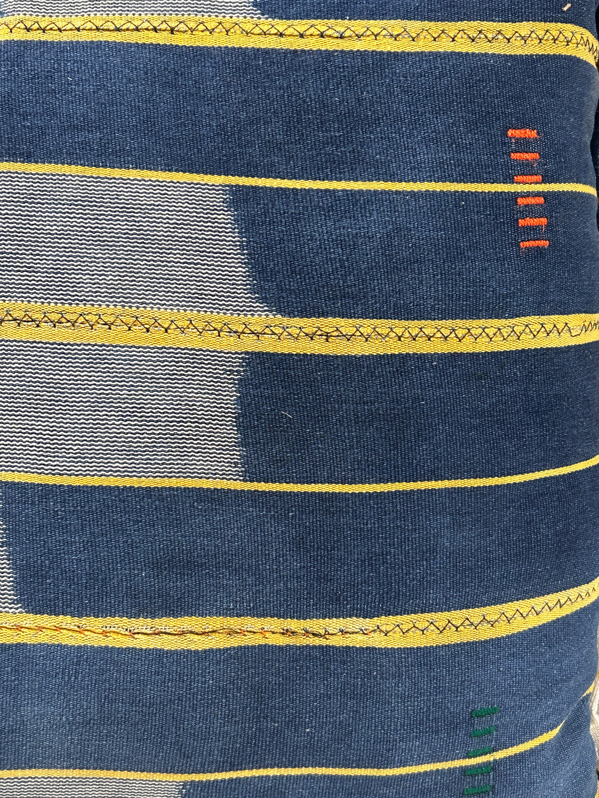 Baule cloth cushion — detail of the hand-stitched strip weave
