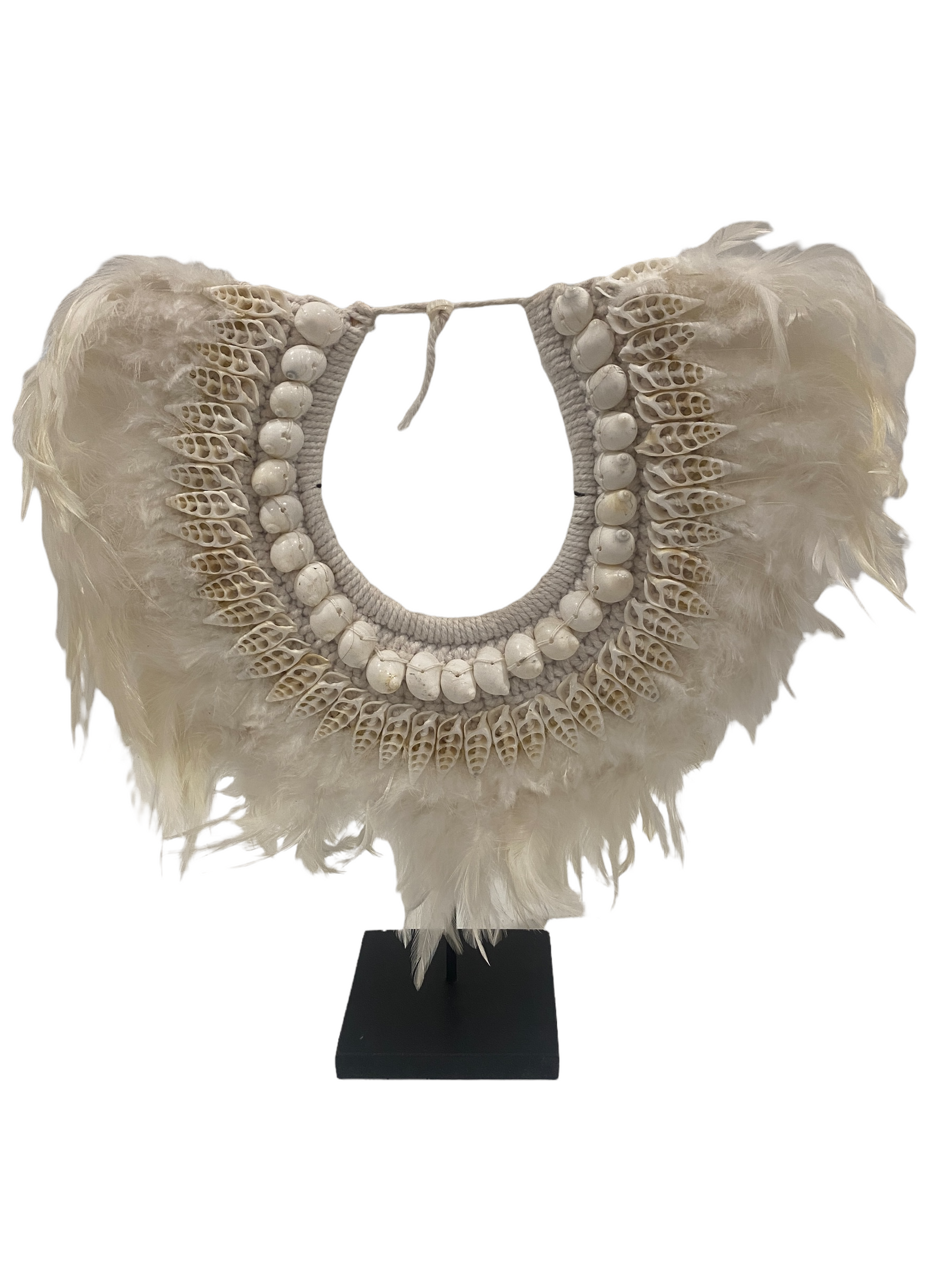 Handmade Indonesian shell and white feather necklace on a display stand