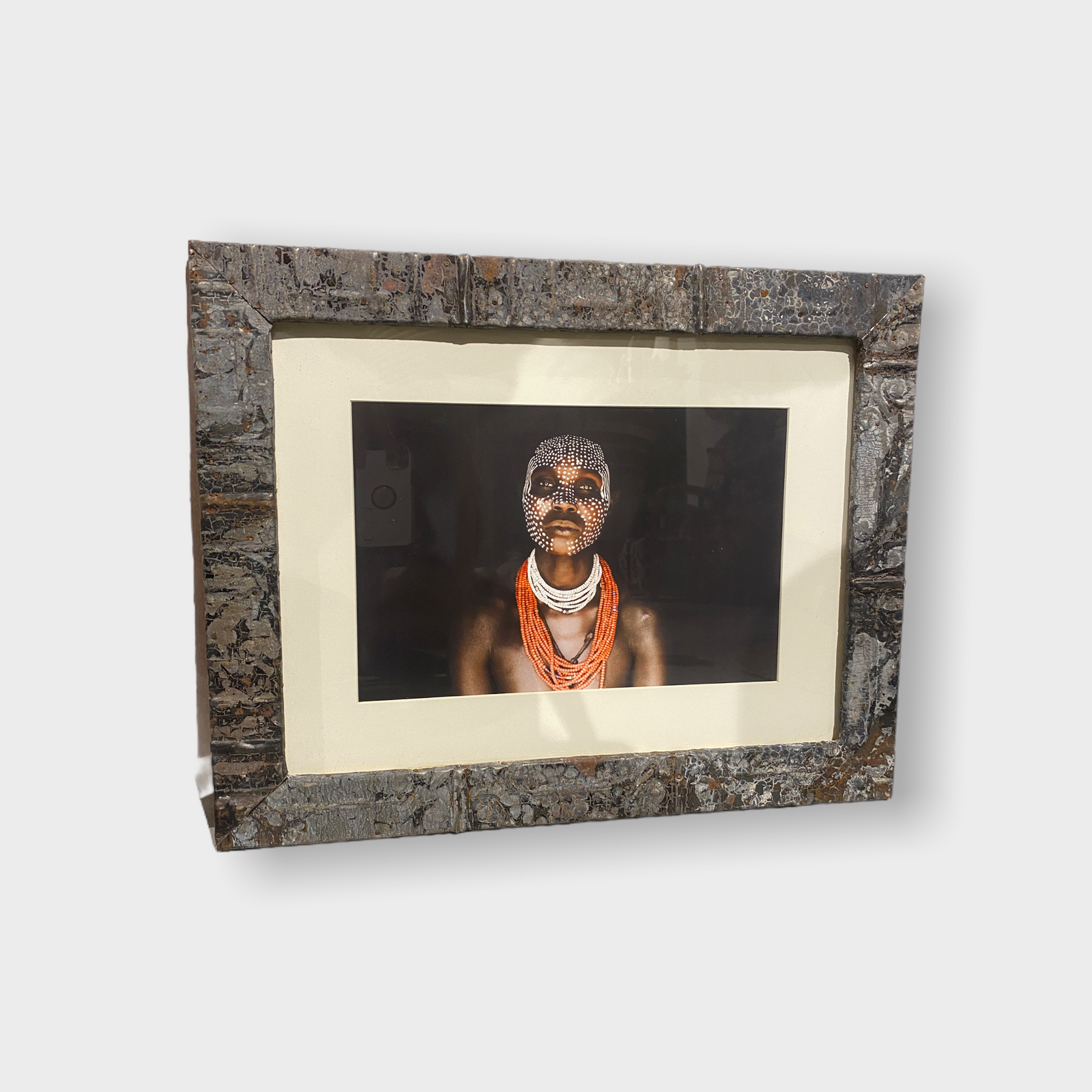 Photos of the vanishing tribes of the Omo Valley in Ethiopia, framed in a recycled tin ceiling press