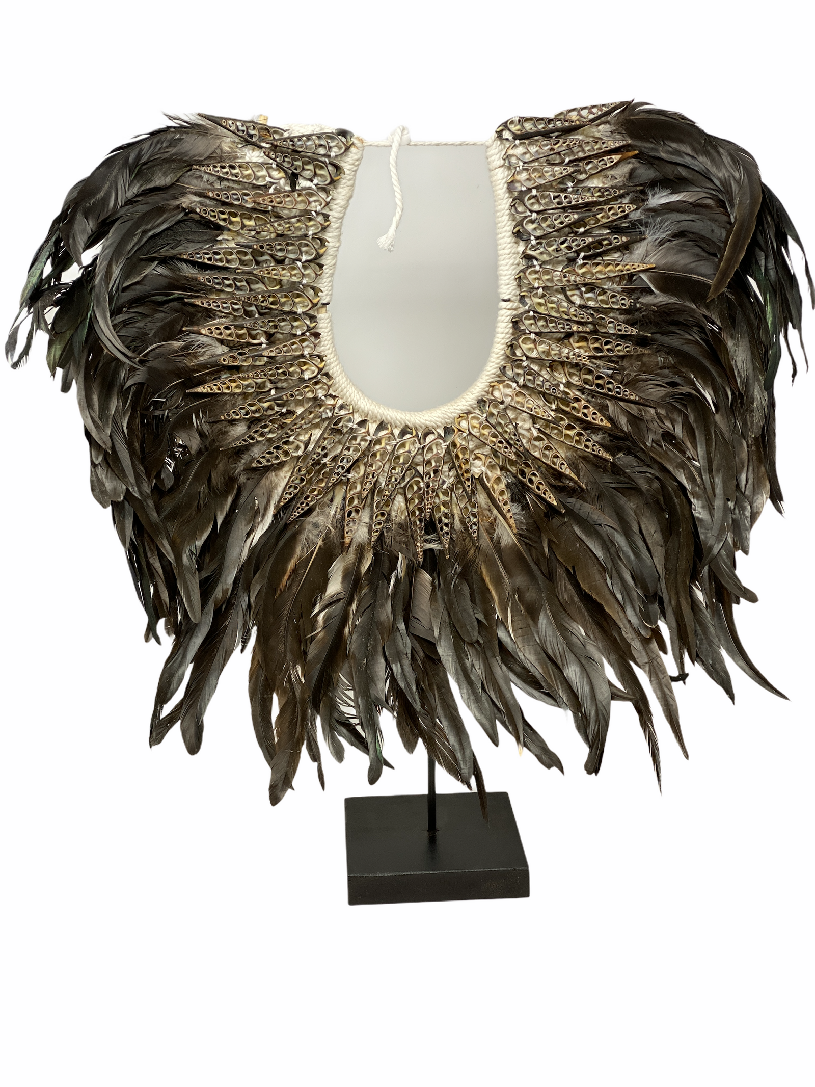 Handmade Indonesian feather and shell necklace on a display stand
